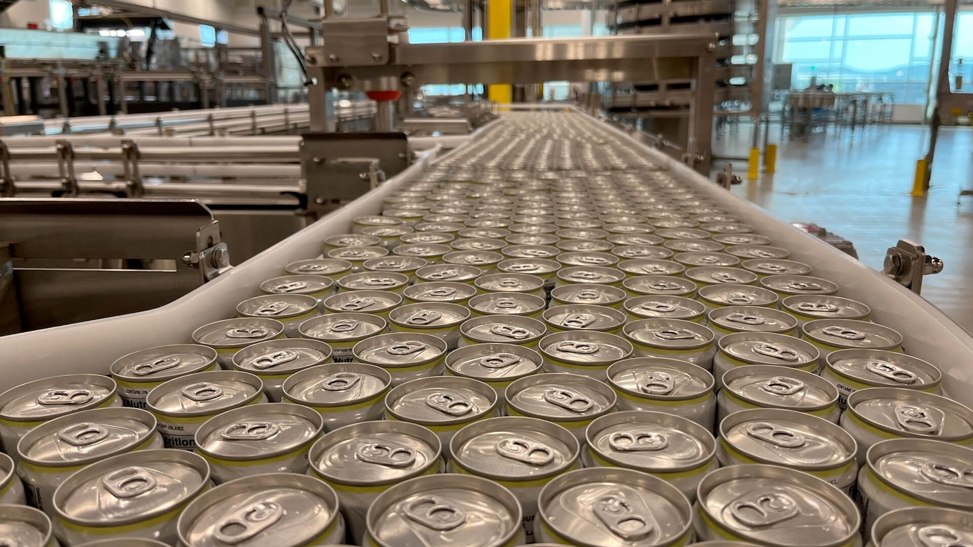 Close up of pop-top aluminum cans on the packing line.