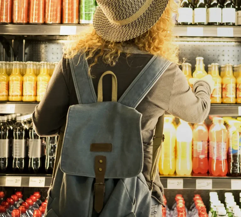 Woman reaching for beverage at store