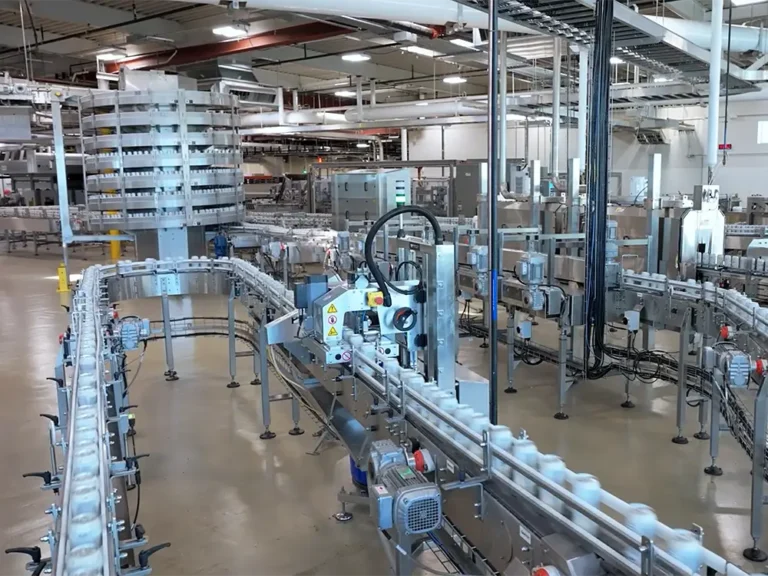 Cans on large machines in a beverage manufacturing plant