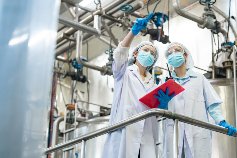 Two women working in a beverage factory.